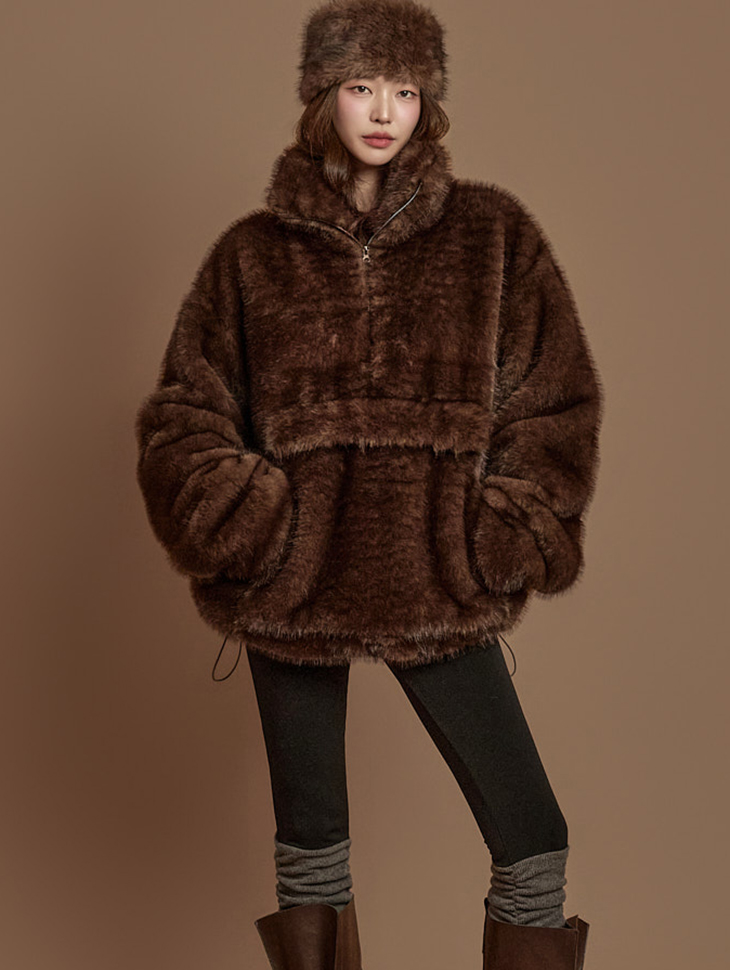 Woman in brown fur coat with oversized sweater and leggings cozy look