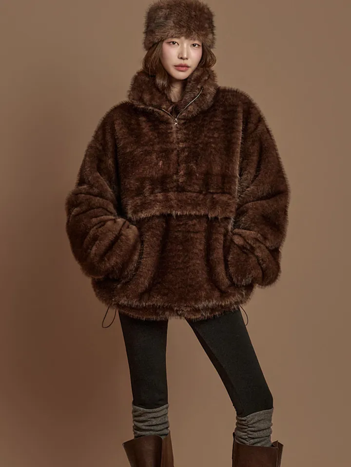 Woman in brown fur coat with oversized sweater and leggings cozy look